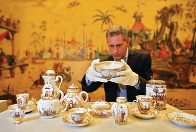 Curator Thomas Rudi inspects Meisser porcelain from Hoeroldt-Chinoiserien (1723-1740) at Grassi Museum, Leipzig, Germany
