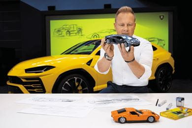 Mitja Borkert head of design at Automobili Lamborghini examines a scale model