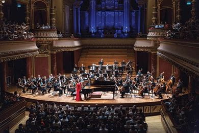 Pianist Khatia Buniatishvili is applauded for her performance with the UN Orchestra conducted by Antoine Marguier in aid of Syrian refugees at the Victoria Hall
