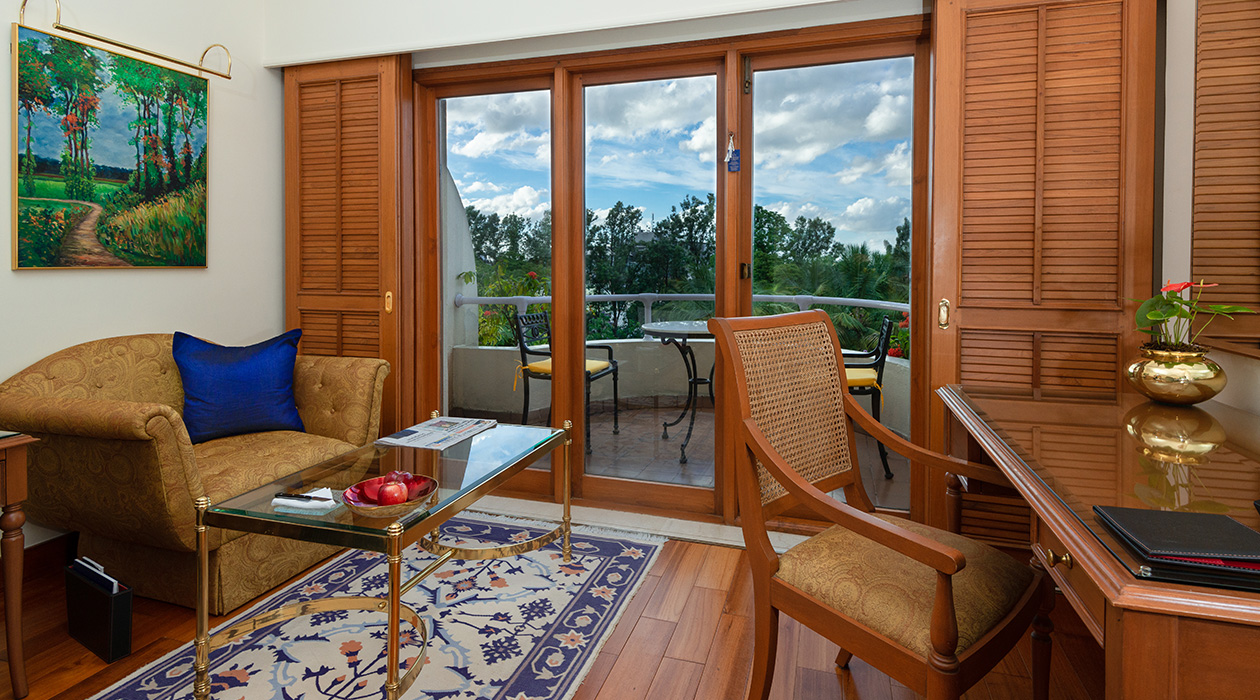 Luxurious hotel room at The Oberoi Bengaluru with balcony.