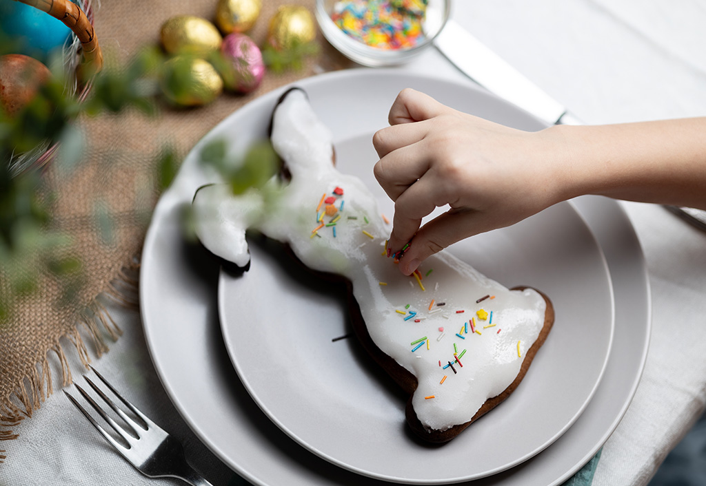 Hand decorates bunny-shaped cake at The Oberoi Sukhvilas Resort.