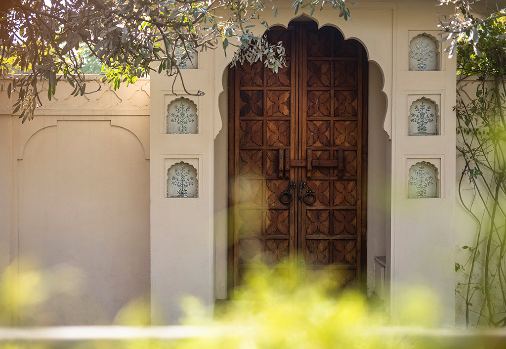 Traditional wooden door at The Oberoi Sukhvilas, Siswan Forest Resort.