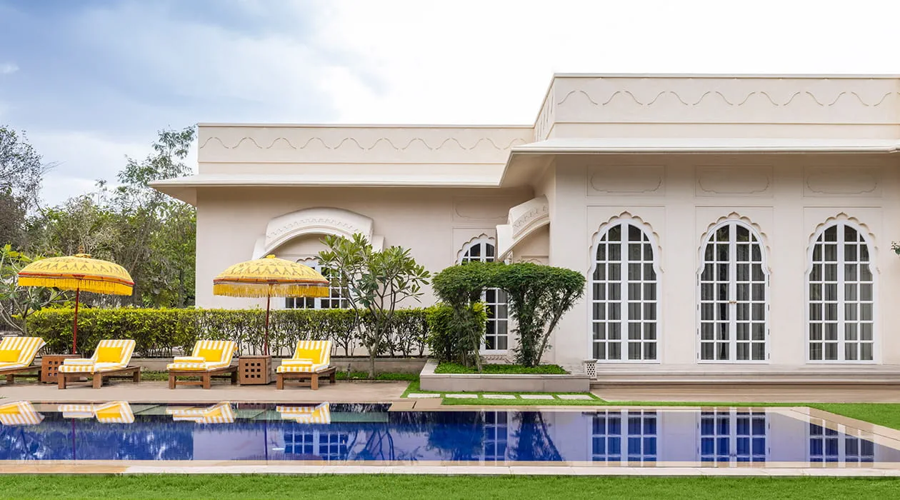 Luxurious poolside with loungers at The Oberoi Sukhvilas resort
