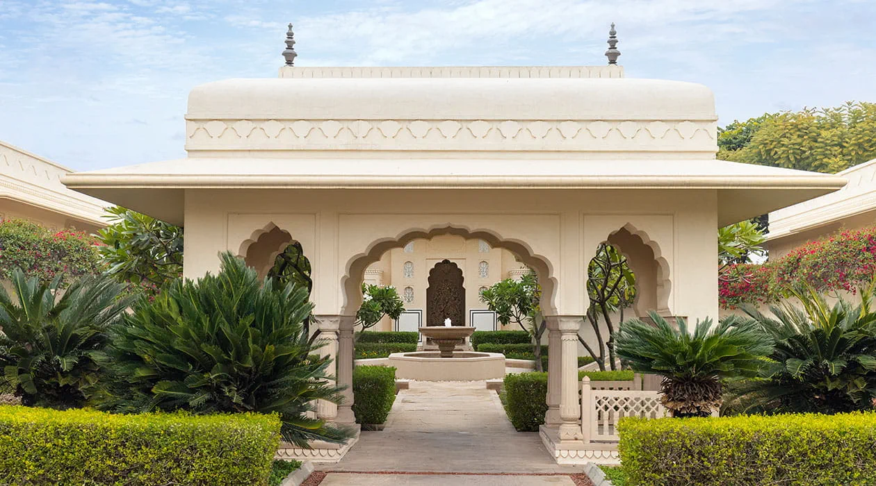 Elegant pavilion surrounded by greenery at The Oberoi Sukhvilas resort.