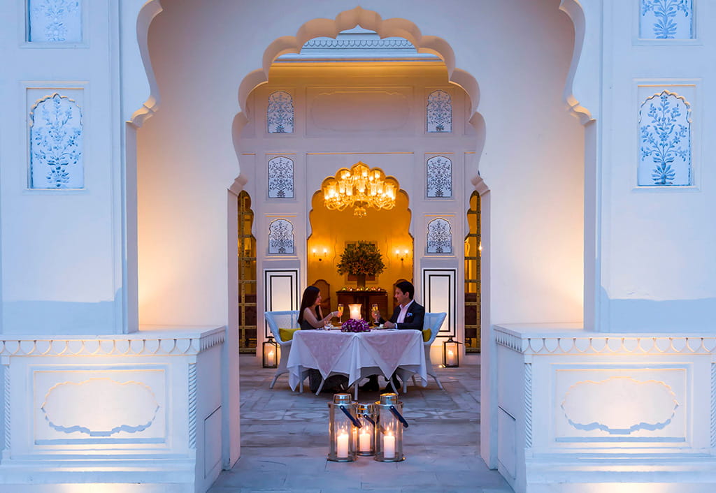A couple dining at The Oberoi Sukhvilas resort courtyard