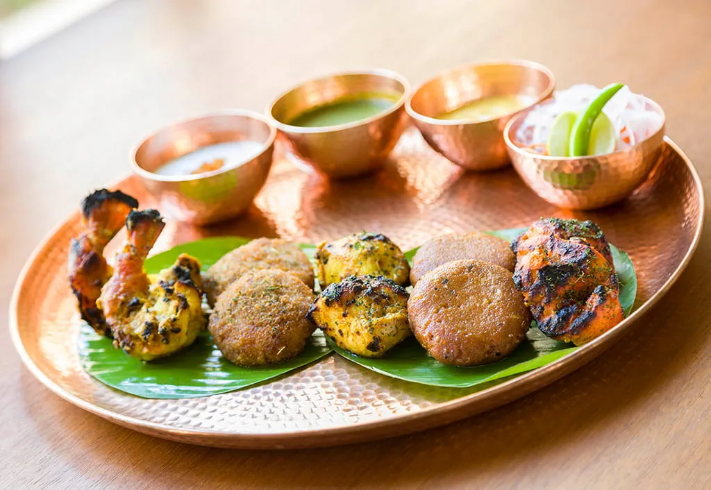 Indian appetizers on banana leaf with dips at Oberoi Sukhvilas resort