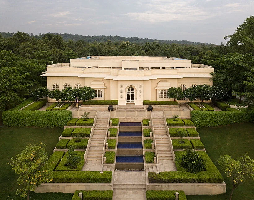 Elegant building at The Oberoi Sukhvilas, surrounded by lush greenery