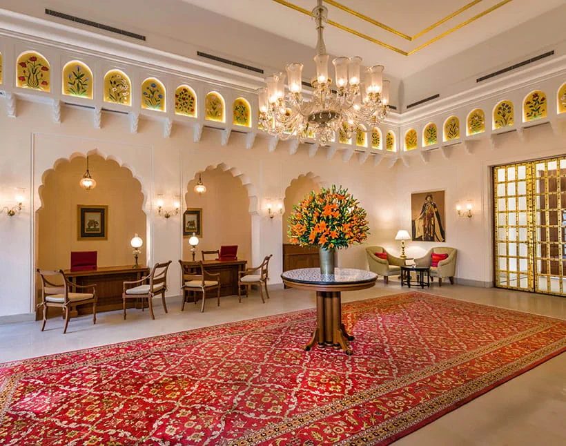 Luxury lobby of The Oberoi Sukhvilas, with chandelier and floral centerpiece