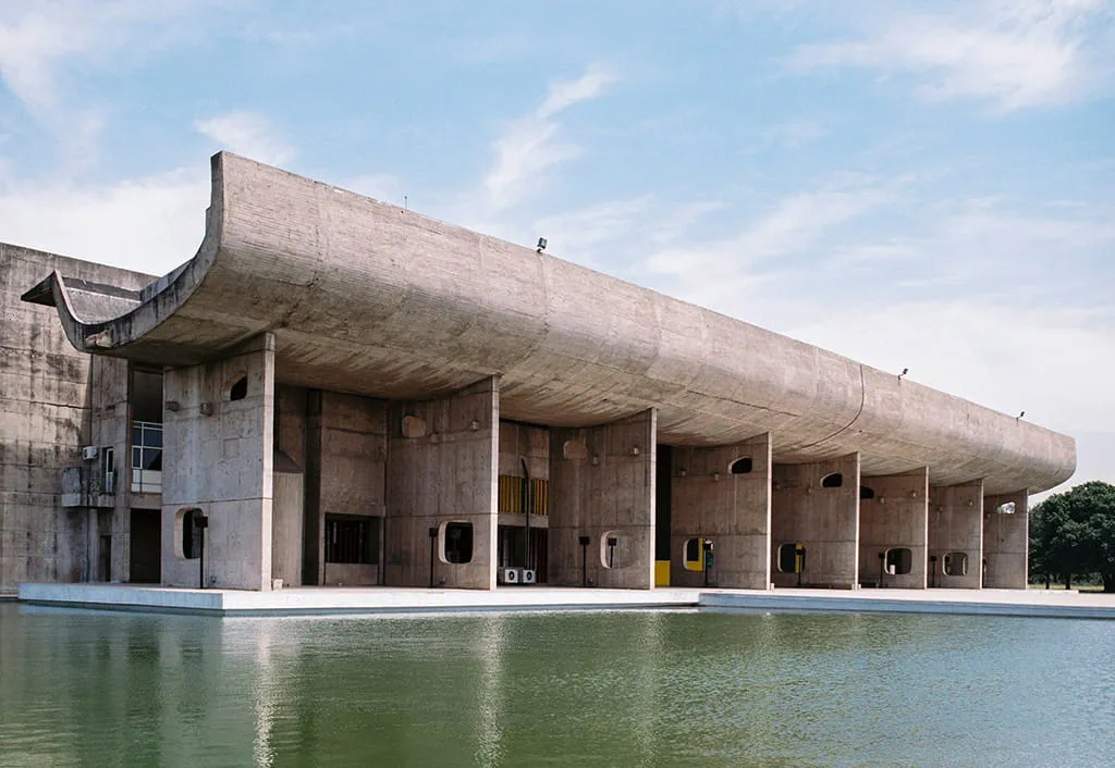 Concrete building by water, clear sky, near Siswan forest resort