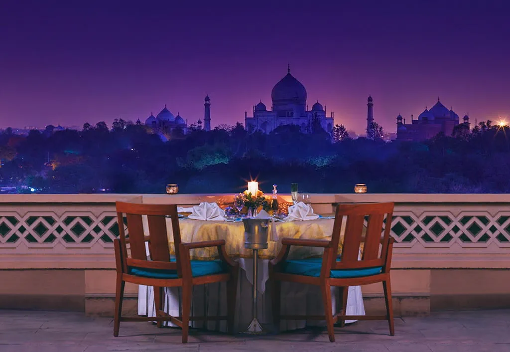Candlelit dinner on a private balcony with Taj Mahal views at The Oberoi Amarvilas, Agra.