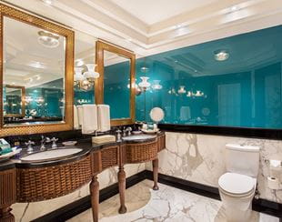 Well-appointed bathroom in the Deluxe Suite with Balcony at The Oberoi Amarvilas, Agra with sleek marble finish.