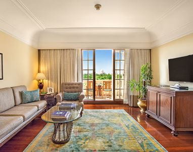 Elegant living room in the Deluxe Suite with Balcony at The Oberoi Amarvilas, Agra, styled with heritage accents.