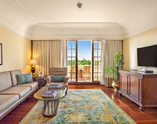 Elegant living room in the Deluxe Suite with Balcony at The Oberoi Amarvilas, Agra, styled with heritage accents.