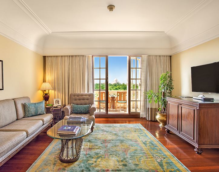 Elegant living room in the Deluxe Suite with Balcony at The Oberoi Amarvilas, Agra, styled with heritage accents.