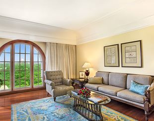 Refined living area of the Deluxe Suite at The Oberoi Amarvilas, Agra with plush furniture and soft lighting.