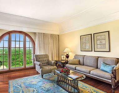 Refined living area of the Deluxe Suite at The Oberoi Amarvilas, Agra with plush furniture and soft lighting.