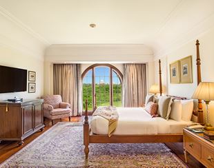Comfortable bedroom in the Luxury Suite at The Oberoi Amarvilas, Agra with warm lighting and plush bedding.