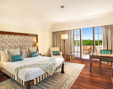 Premier Room with a private balcony at The Oberoi Amarvilas, Agra offering views of the Taj Mahal and lush gardens.