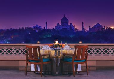 Candlelit dinner on a private balcony with Taj Mahal views at The Oberoi Amarvilas, Agra.