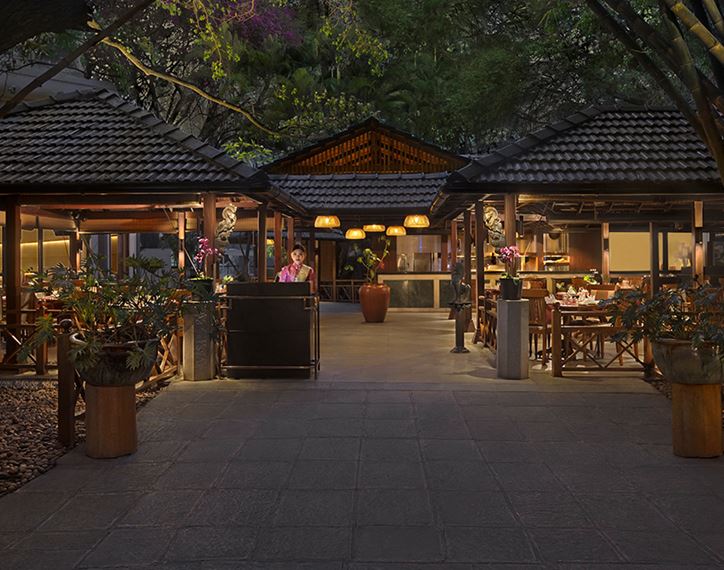 Oberoi Bengaluru restaurant entrance, elegant evening setting, ambient lighting.
