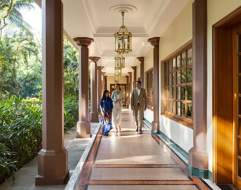 Three people walking in hallway, The Oberoi Bengaluru.