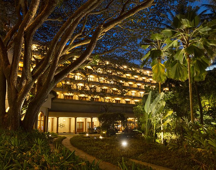  The Oberoi Bengaluru hotel illuminated at night amid lush garden setting