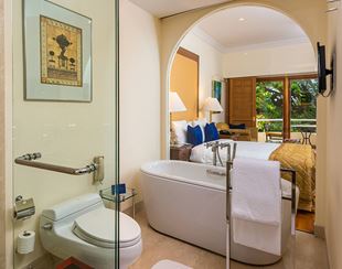 Luxurious bathroom and bedroom at The Oberoi Bengaluru hotel.