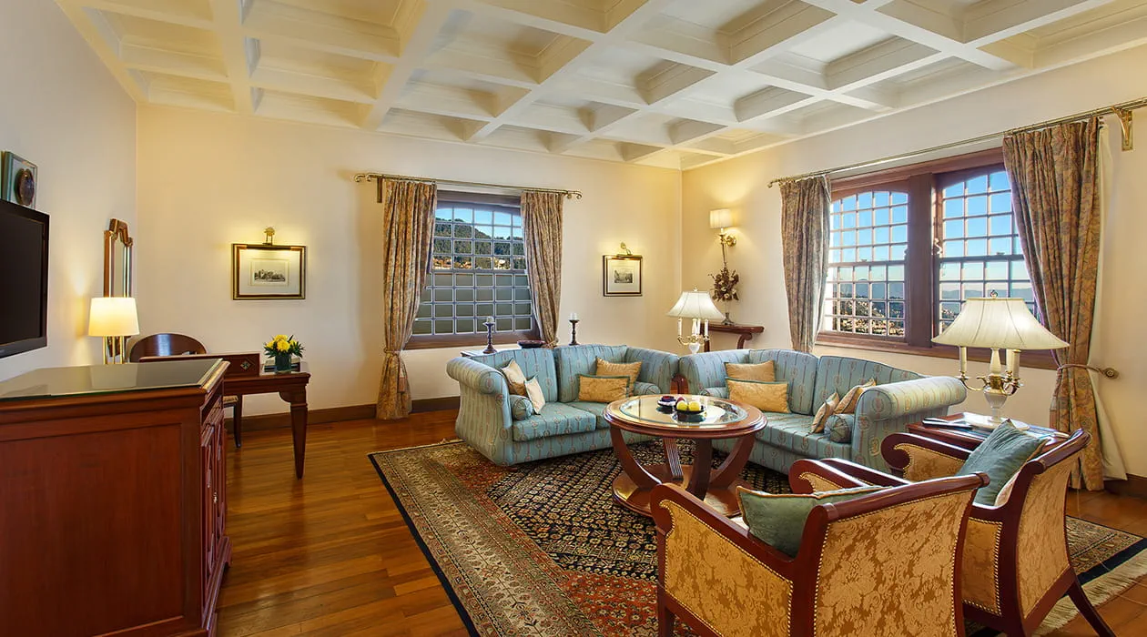 Luxurious hotel suite with elegant furniture, large windows at The Oberoi Cecil