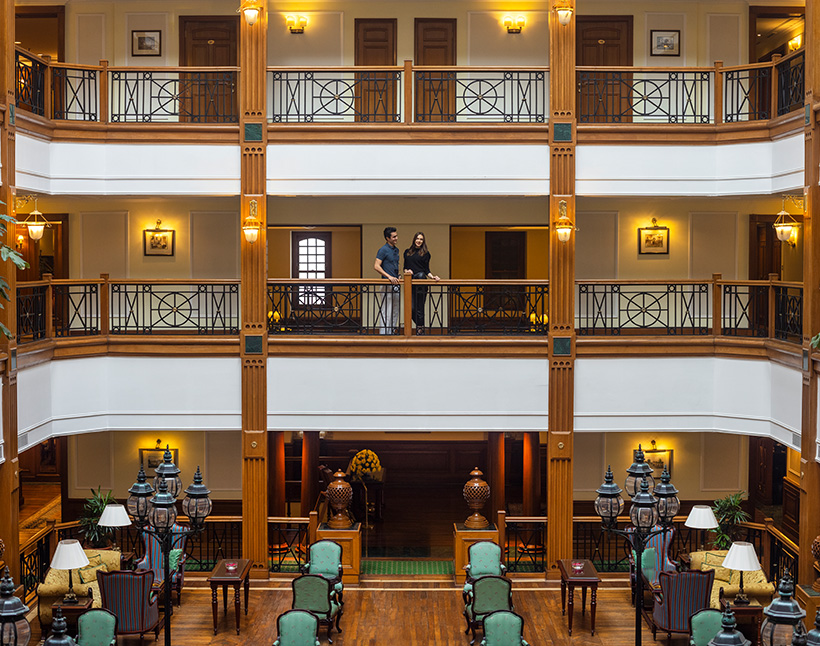 Luxurious hotel interior in Shimla with guests on balcony