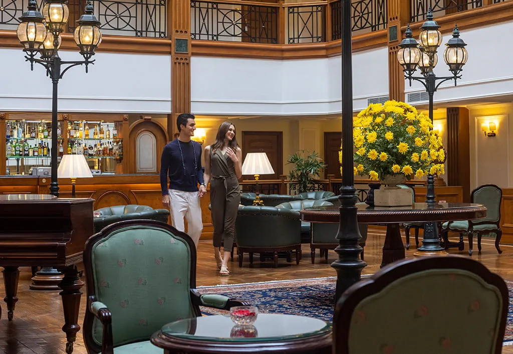 Couple walking in luxury hotel lobby at The Oberoi Cecil, Shimla