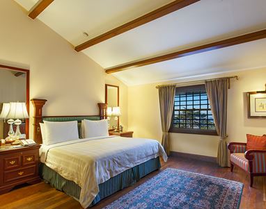 ALT: Cozy luxury hotel room with view, elegant decor, and rich furnishings