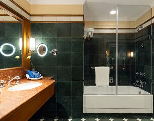 Luxury bathroom in The Oberoi Cecil, Shimla, featuring marble and glass fixtures