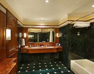 Elegant bathroom with twin sinks, bathtub, and luxury decor in Shimla's 5-star hotel
