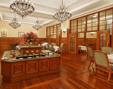 Luxurious dining area with chandeliers at The Oberoi Cecil, Shimla