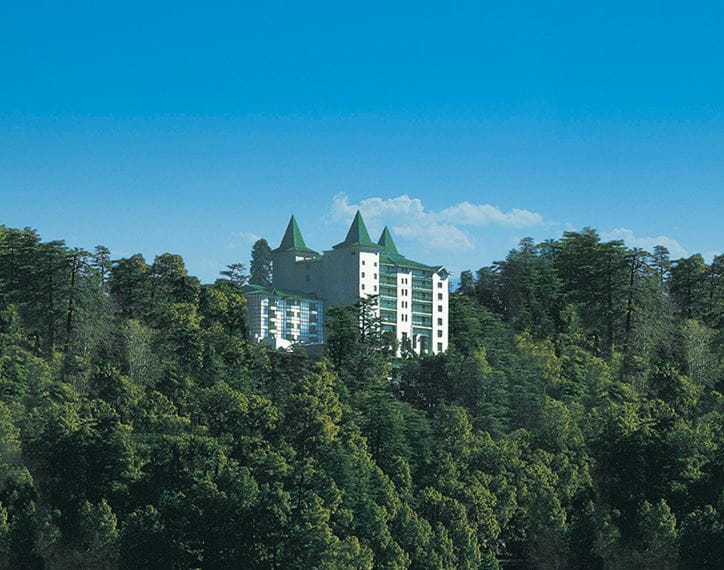 Luxury hotel nestled in Shimla's greenery; The Oberoi Cecil visible