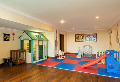 Kids playroom with slide and playhouse in luxury Shimla hotel