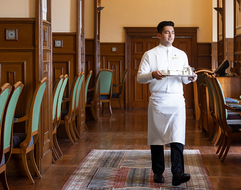 Waiter serving tea at luxury hotel The Oberoi Cecil, Shimla