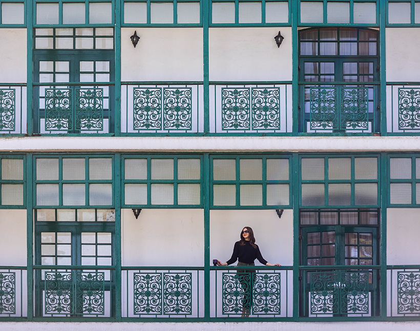 Woman standing on balcony of The Oberoi Cecil in Shimla