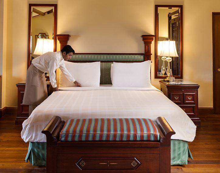 Hotel staff preparing bed, luxurious room at The Oberoi Cecil, Shimla