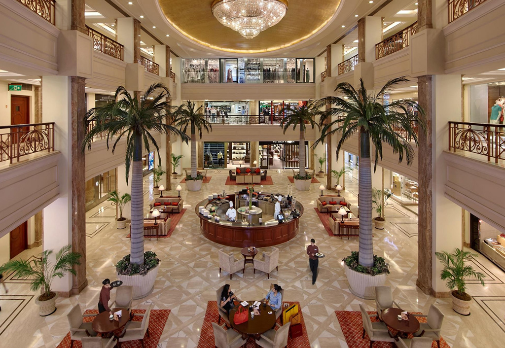 Elegant lobby with seating, palm trees at The Oberoi New Delhi