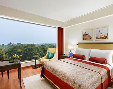 A luxurious hotel room with large window and city view 5-star hotel, The Oberoi New Delhi