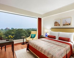 A luxurious hotel room with large window and city view 5-star hotel, The Oberoi New Delhi