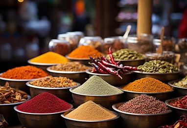 Colourful spices displayed in bowls at a vibrant market stall