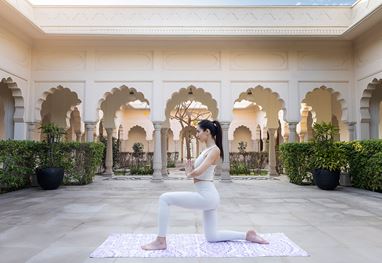Yoga practice in courtyard at The Oberoi Sukhvilas, Siswan Forest Resort