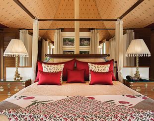 Luxurious bedroom with red pillows, lamps, hotel room at The Oberoi Sukhvilas