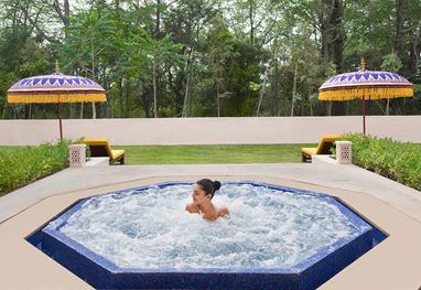 Person relaxing in hot tub at 5-star Oberoi Sukhvilas Resort