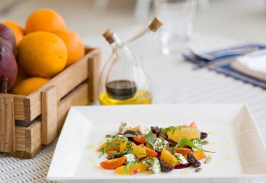 Plate with colorful salad, oil bottle, and fruit at Oberoi Sukhvilas