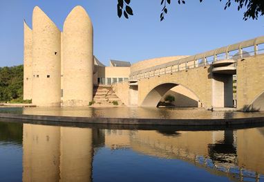 Modern architecture reflected in water at The Oberoi Sukhvilas resort