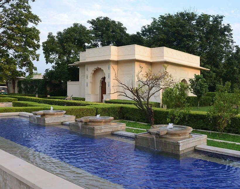 Elegant building and fountains at The Oberoi Sukhvilas resort, serene gardens
