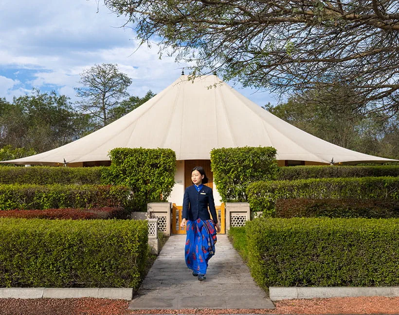 Person walking outside luxury tent at 5-star Oberoi Sukhvilas Resort